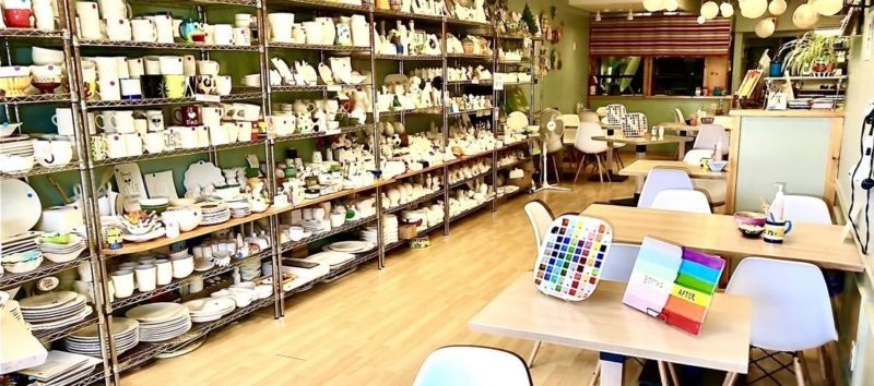 Shelves of unpainted pottery in the studio