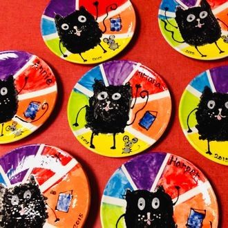 Kids' hand-painted plates with cat drawings